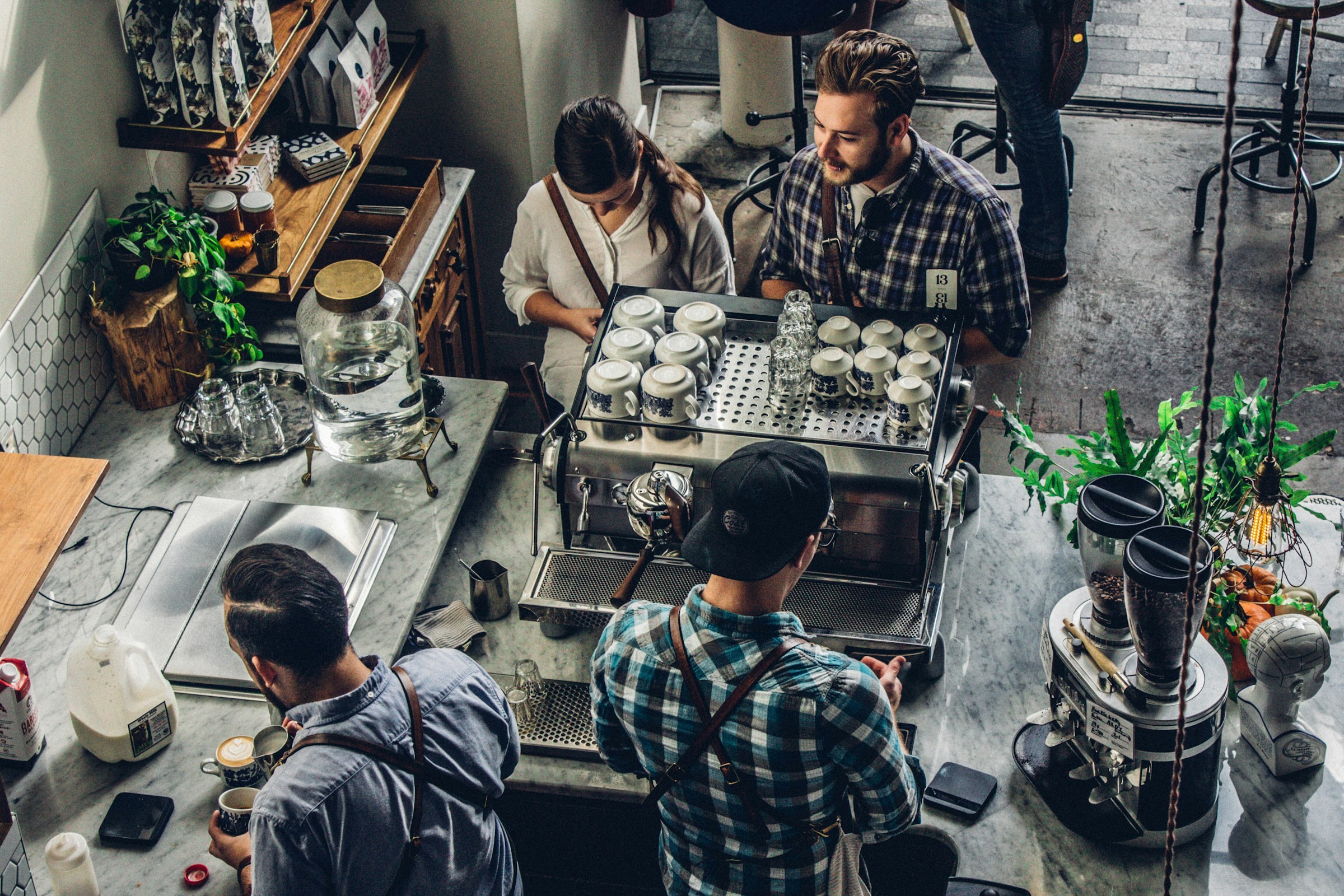 Customers being served at the counter of a busy independent coffee shop